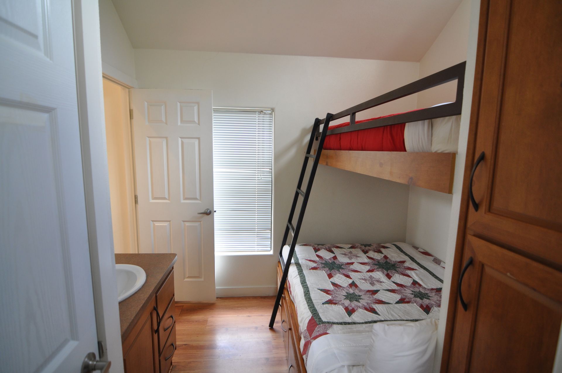 A bedroom with a bunk bed and a sink