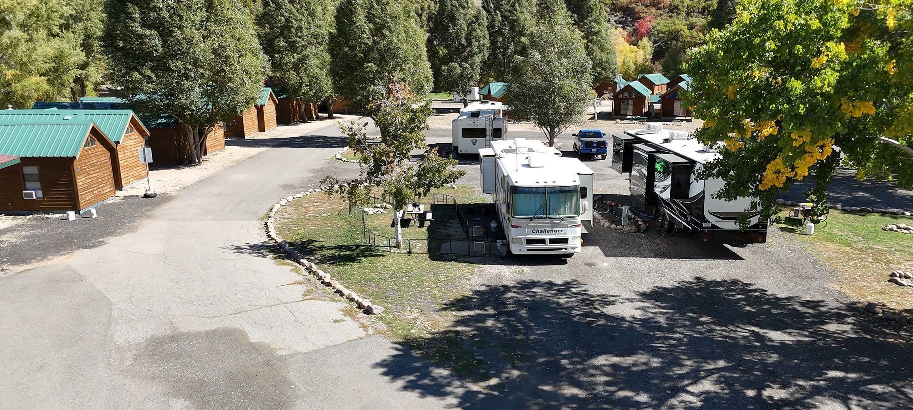 A group of rvs are parked in a parking lot.