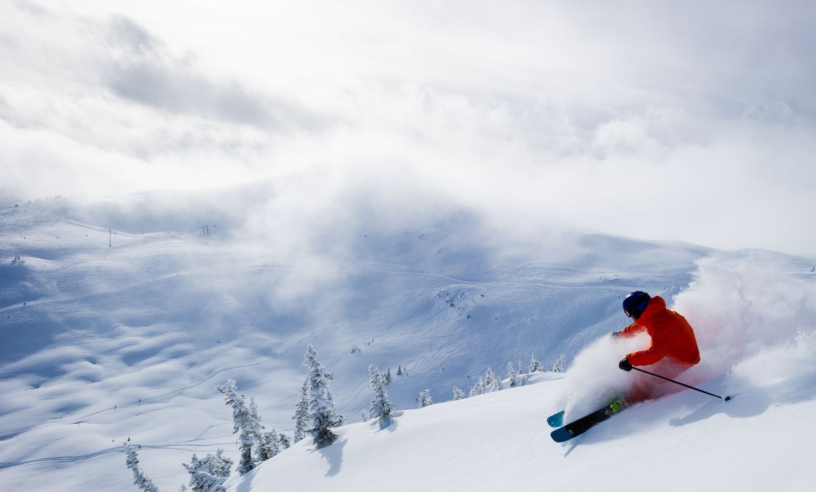 A person is skiing down a snow covered slope.