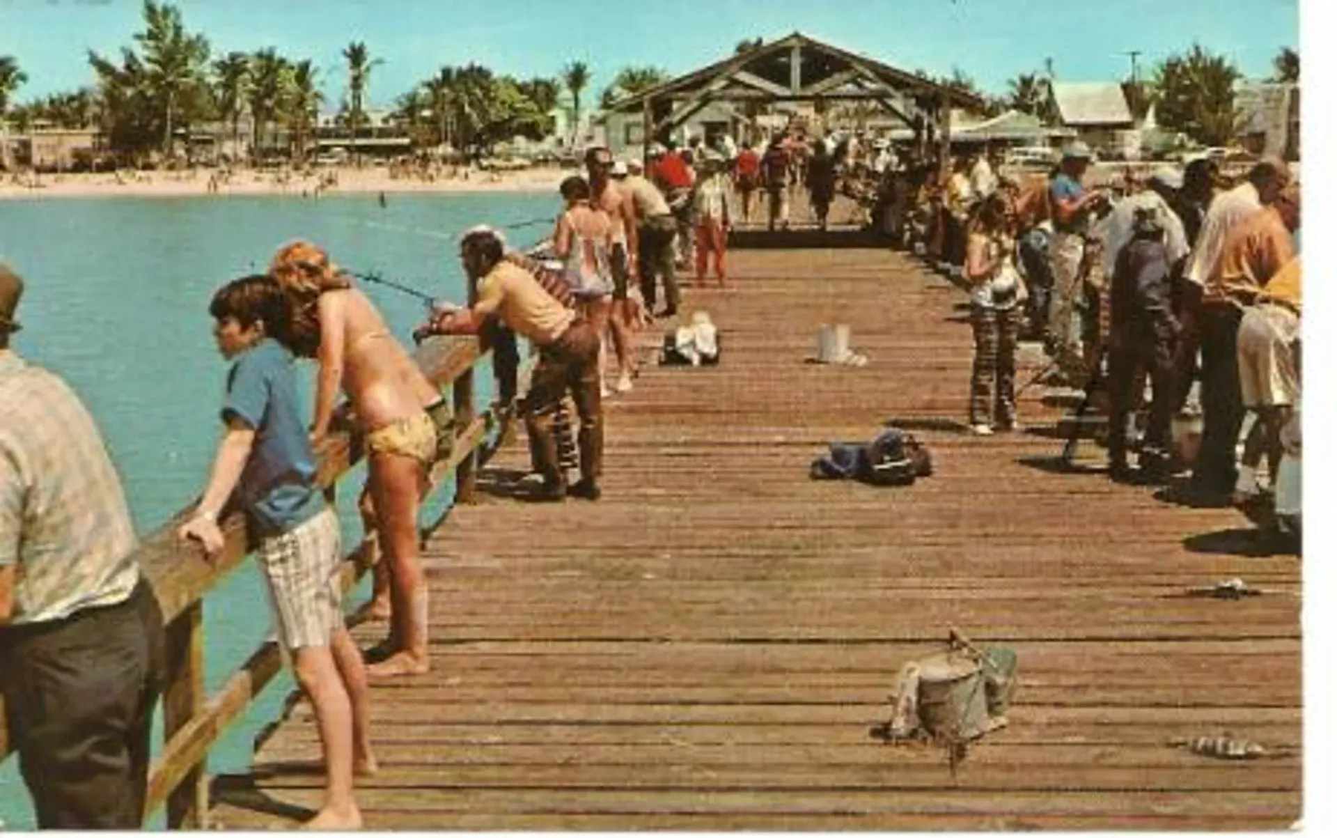 A group of people are fishing on a pier