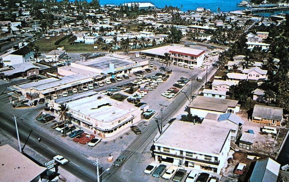 An aerial view of a city with a building that says tesla on it