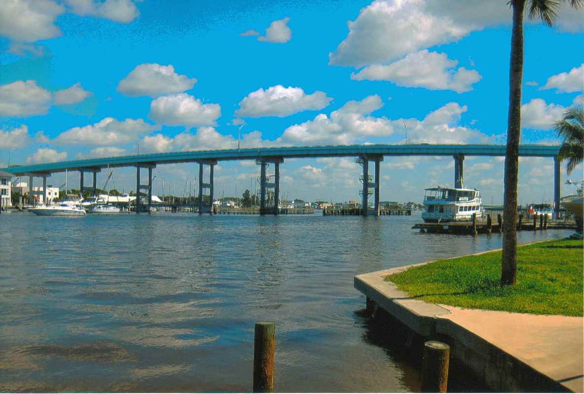 A bridge over a body of water with boats in it
