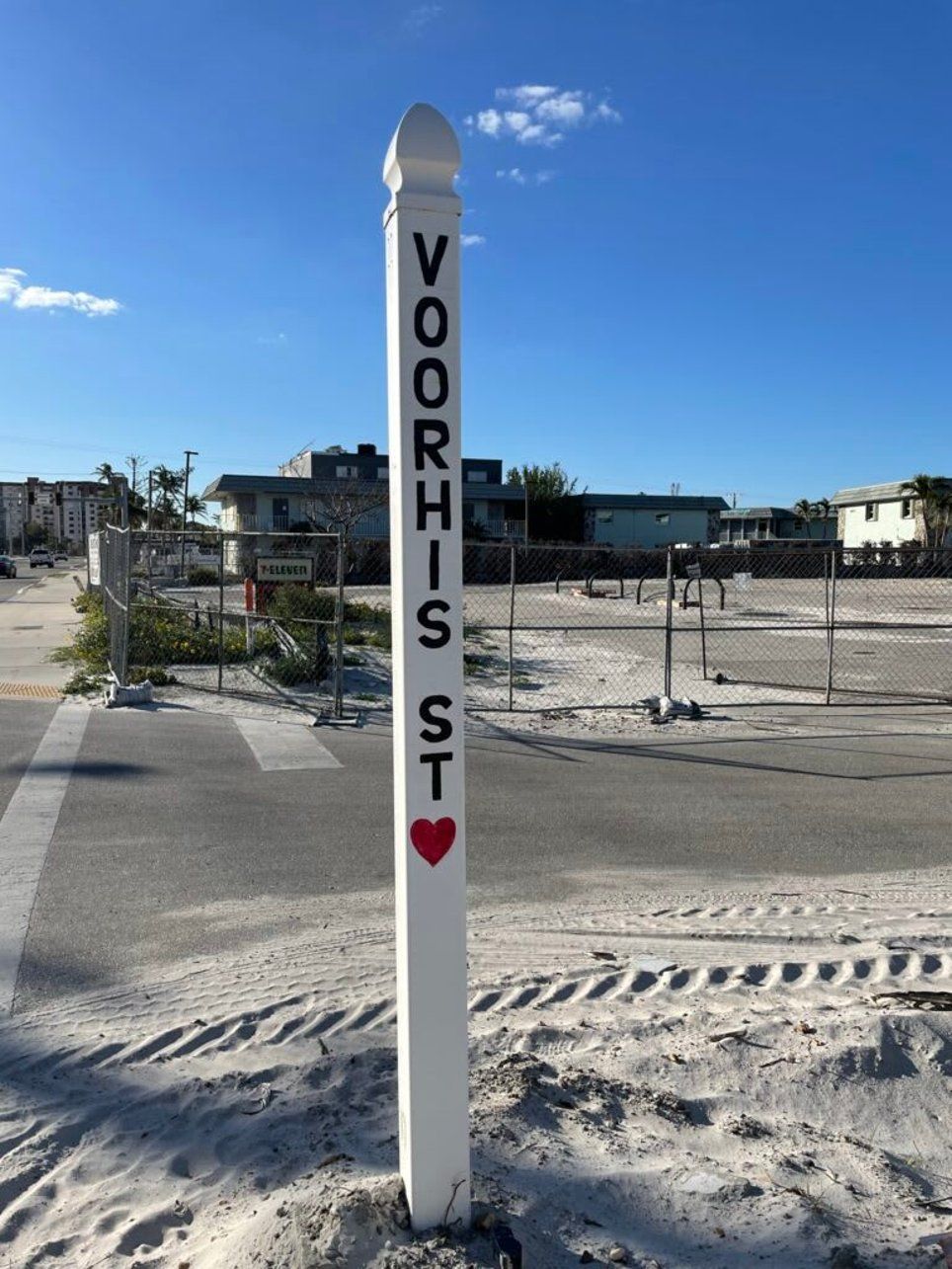 A white pole with voorhis st written on it
