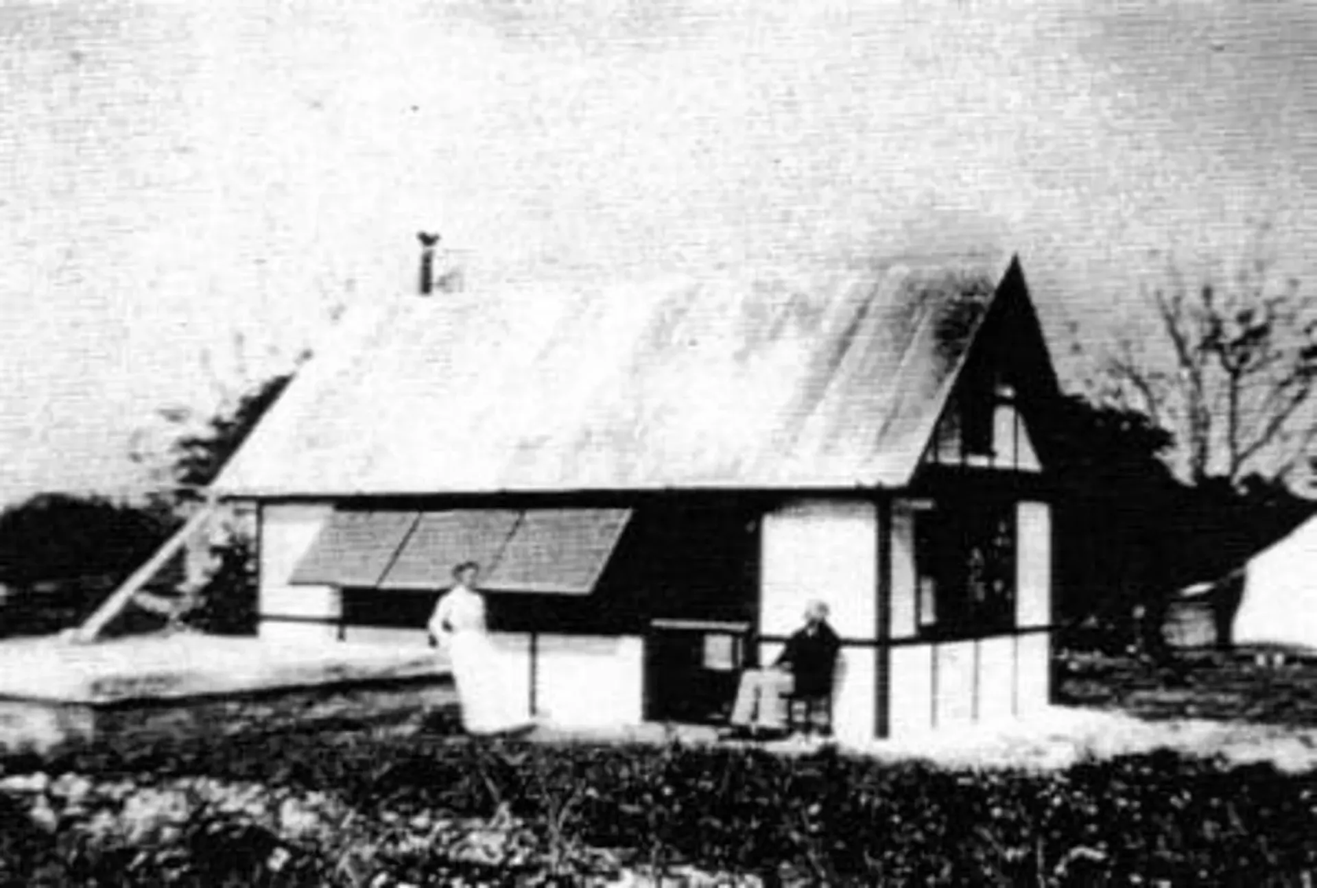 A black and white photo of a small house