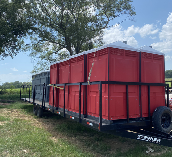 A trailer with a bunch of red containers on it