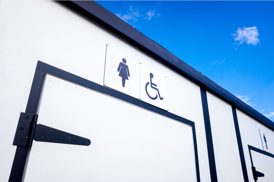 A white building with a handicapped sign on it