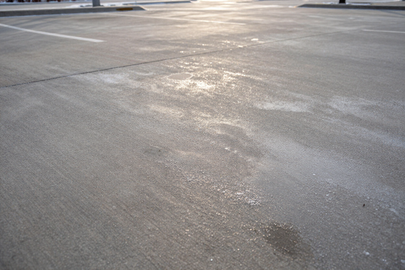 Deicer being applied to a commercial parking lot in Michigan