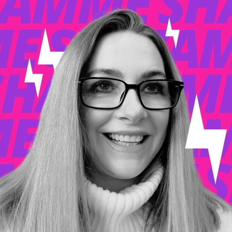 A smiling person wearing glasses and a turtleneck sweater against a pink and purple lightning bolt background.