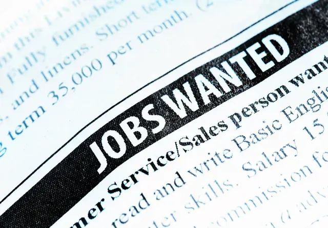 A close-up view of a newspaper classified section featuring a bold header that reads JOBS WANTED.