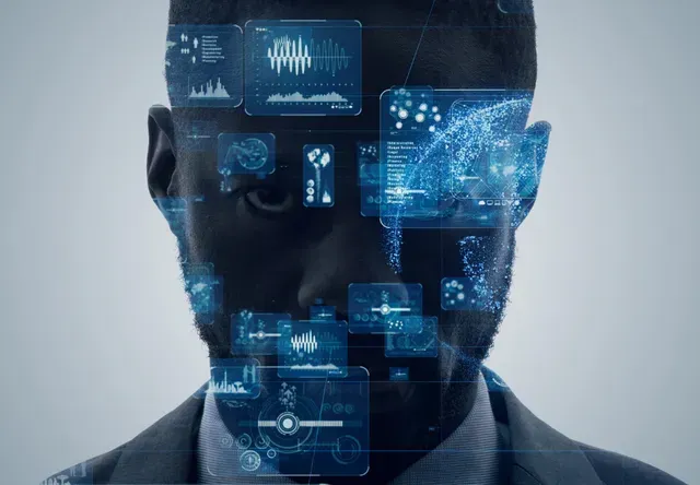 A person in a suit surrounded by glowing, translucent blue digital data interfaces and futuristic technical graphics.