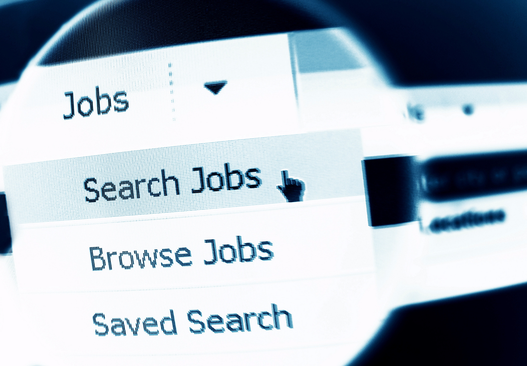 A computer screen shows a blue-tinted drop-down menu with options: Search Jobs, Browse Jobs, and Saved Search.
