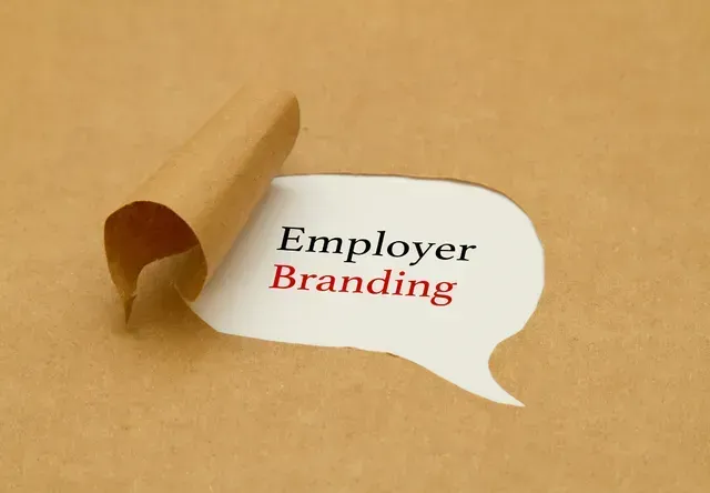 Brown paper torn to reveal a speech bubble with the text 