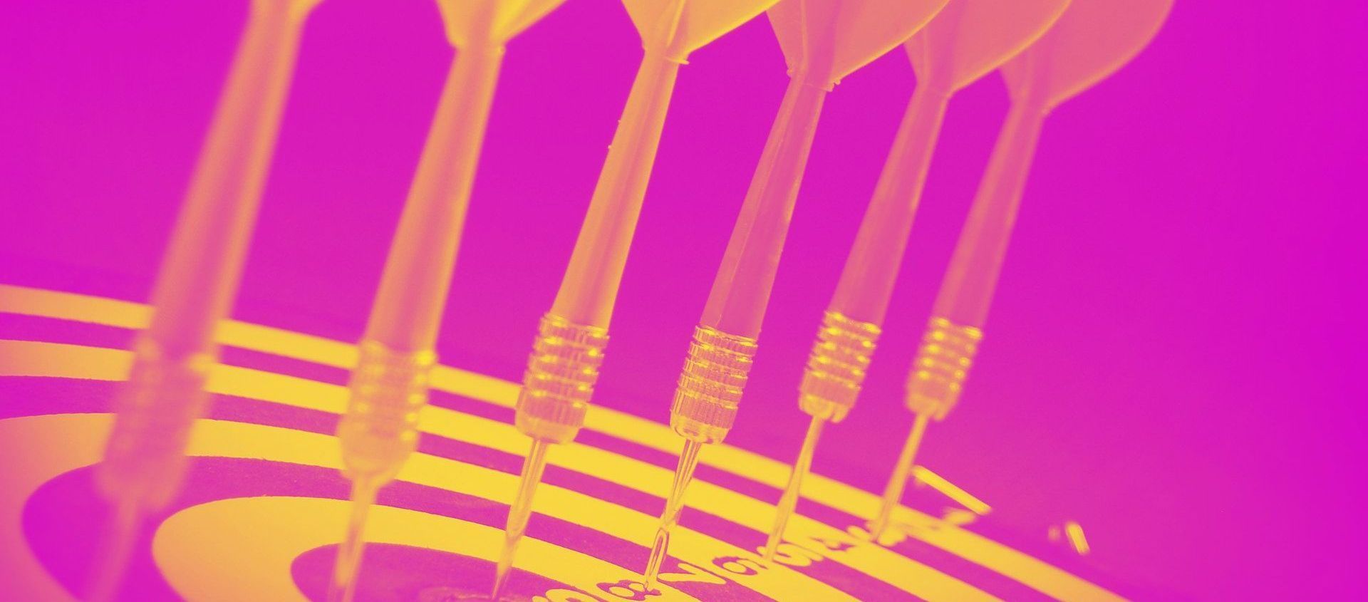 Six darts hitting a target, shown in yellow against a bright pink background.
