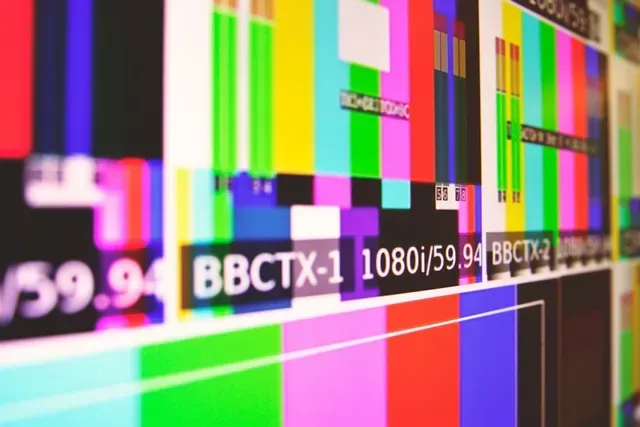 A television broadcast test pattern featuring colorful bars and text labels like 