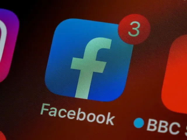A close-up of a Facebook app icon on a mobile device screen, displaying a red notification badge with the number 3.