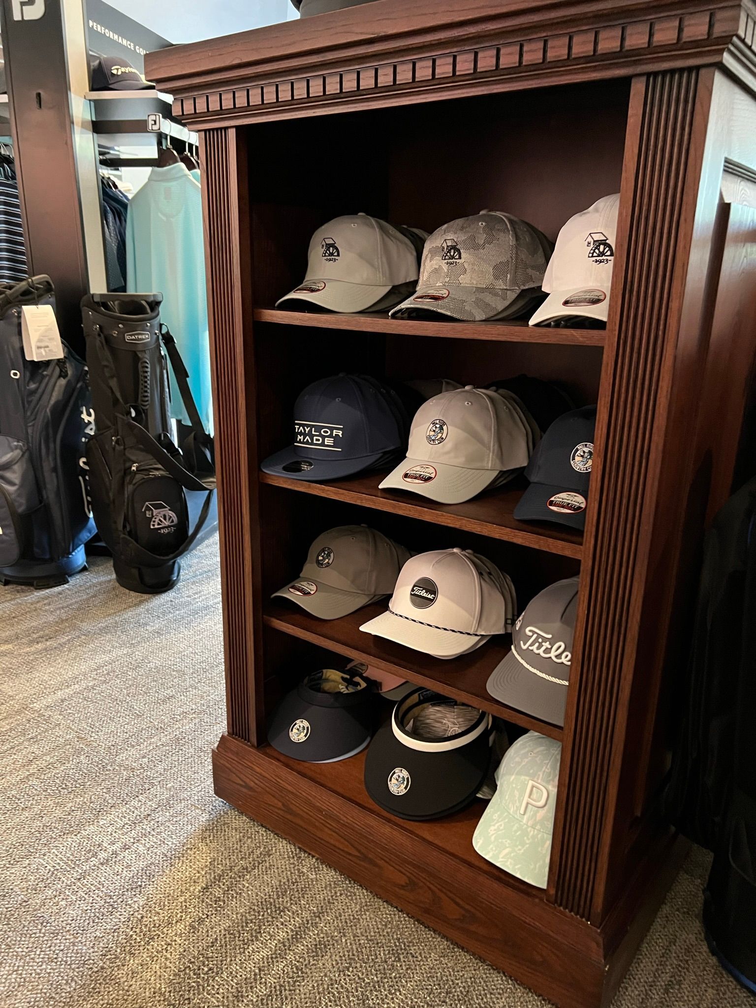 A shelf filled with lots of hats in a room.