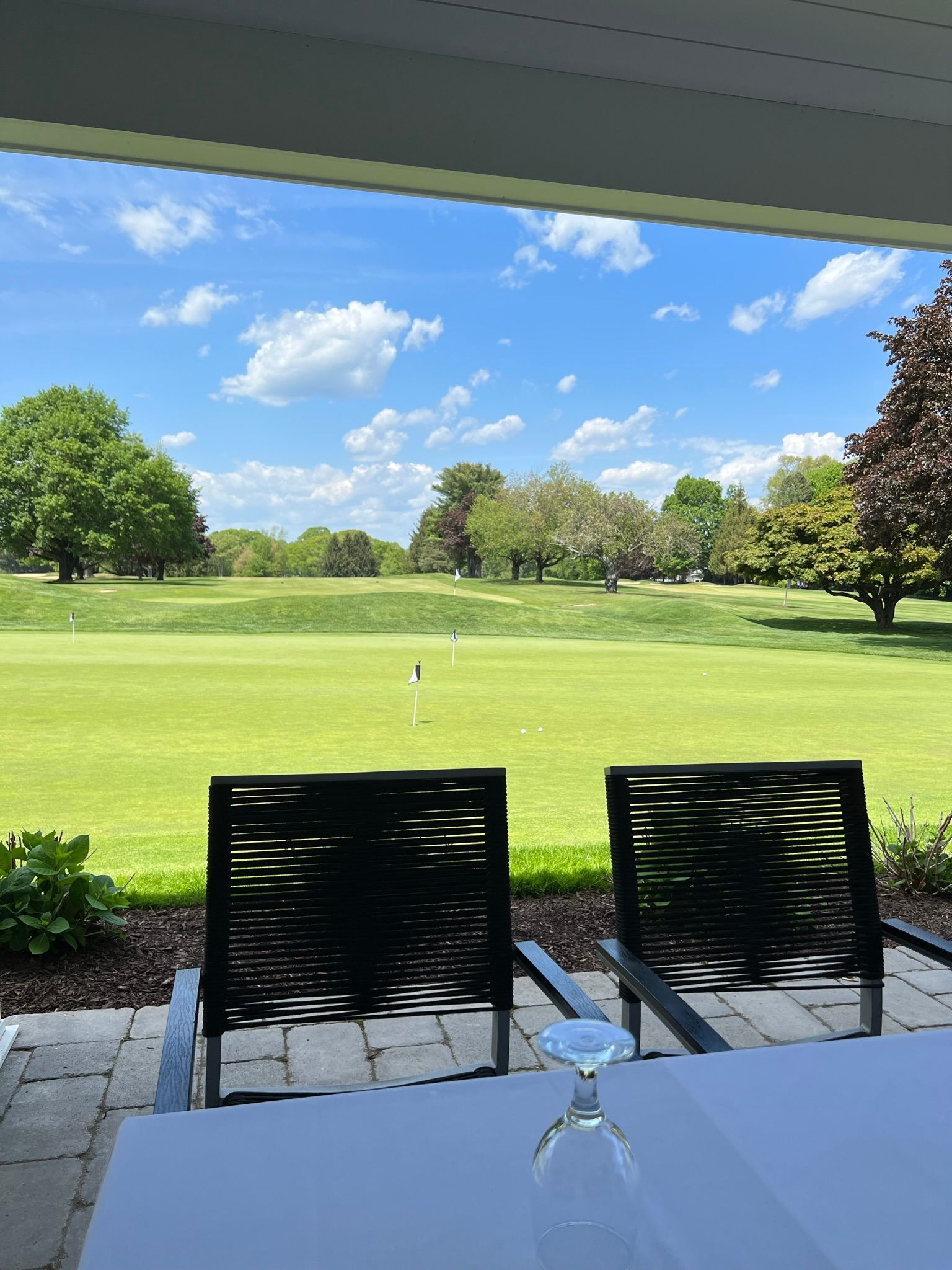 A table and chairs with a view of a golf course