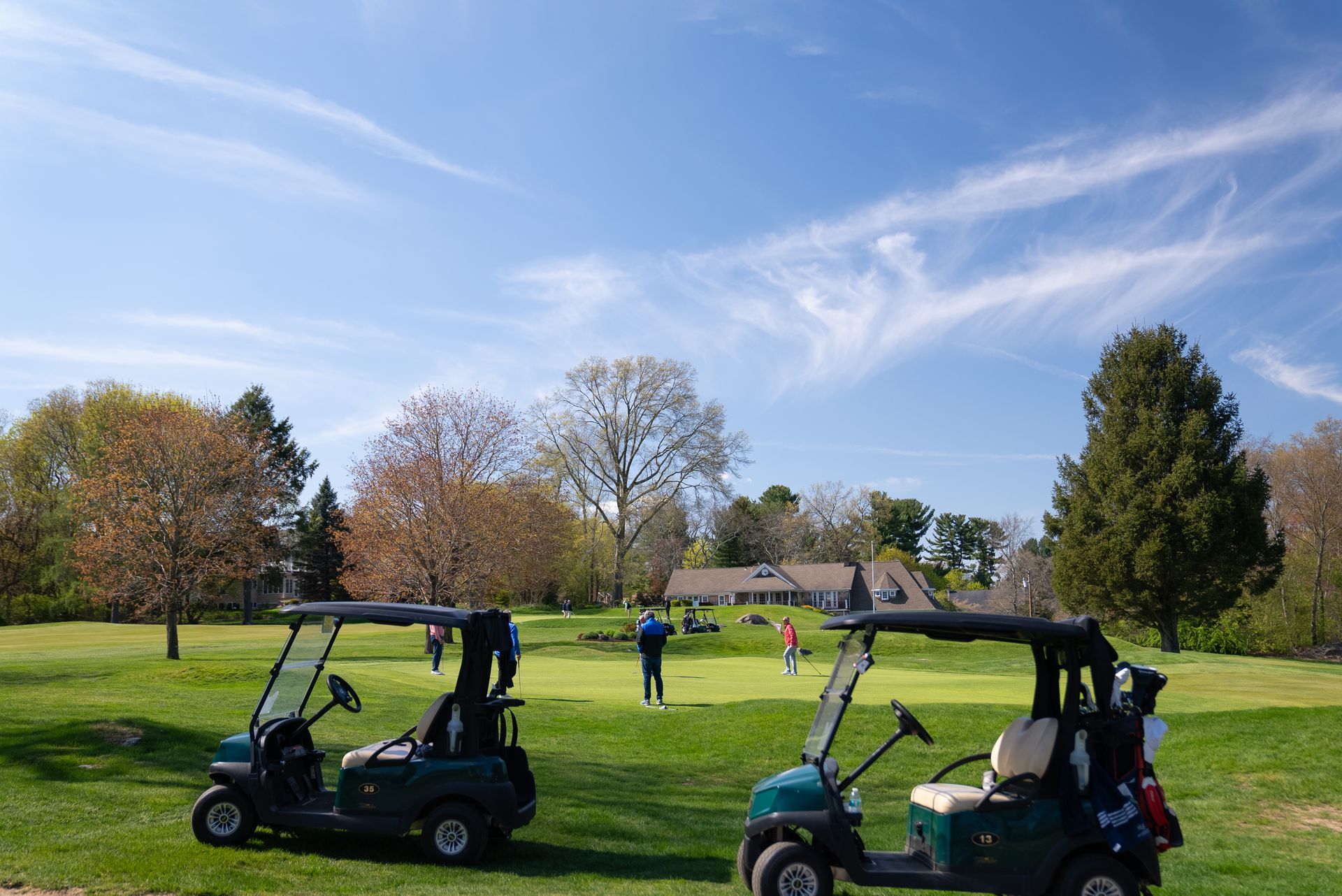 Two golf carts are parked on a golf course.
