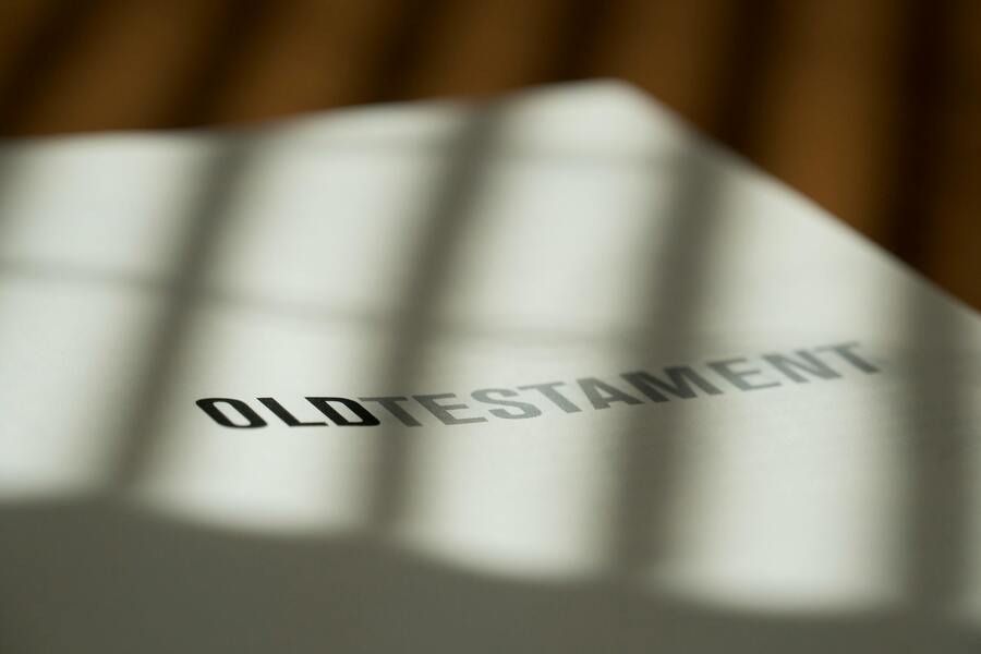 Old Testament text on a white page with shadows from window light