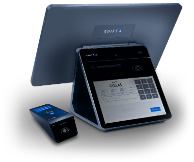 A POS system with a touchscreen display, keypad, and card reader in a modern retail setting.