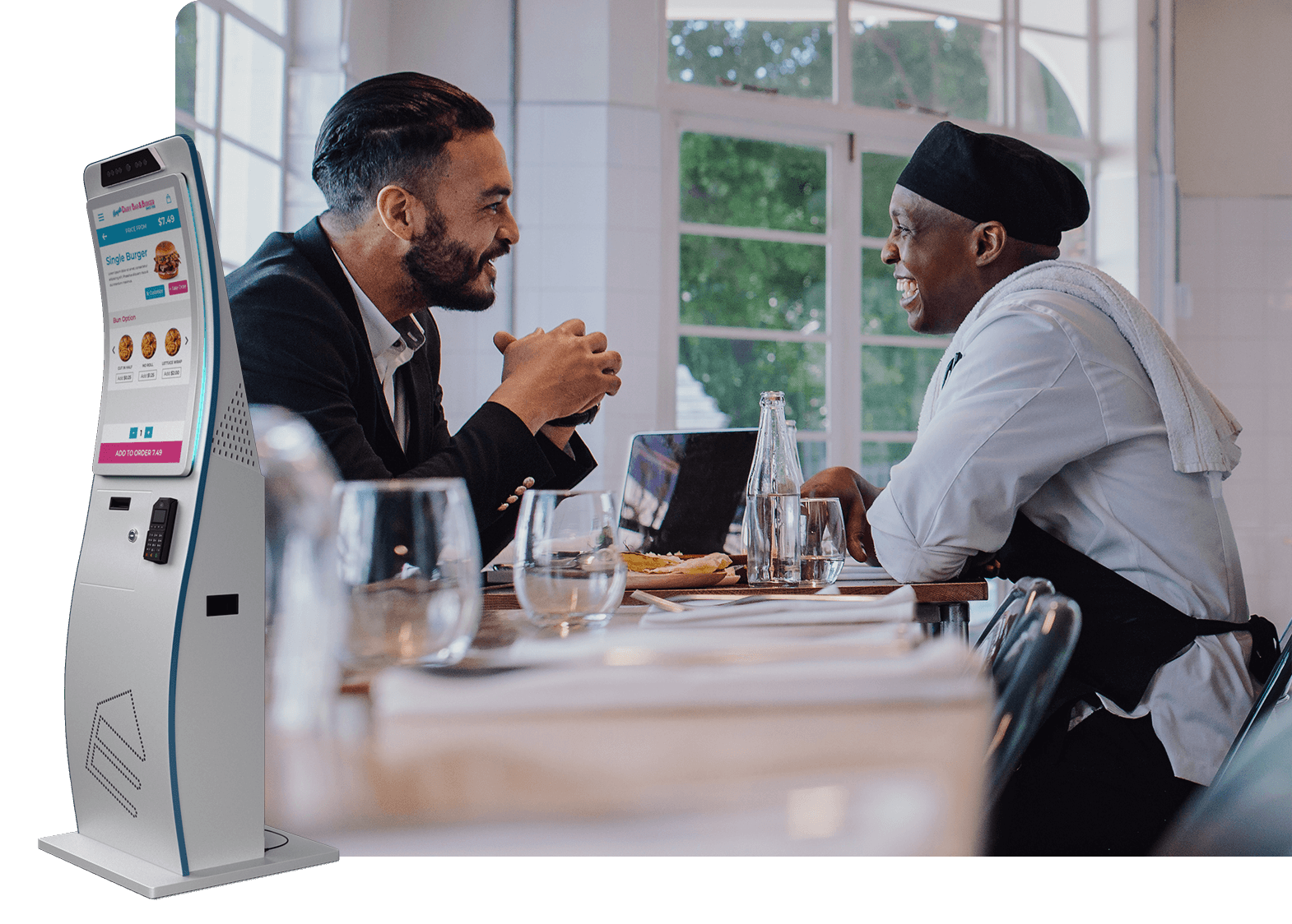 Restaurant scene with a customer and chef talking, a kiosk in the background.