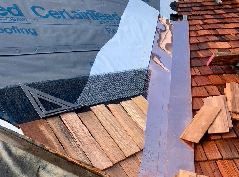 A shingle and copper roof in the building stages