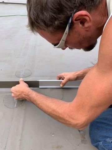 Rodd Roofing employee Josh Holycross installing a new roof