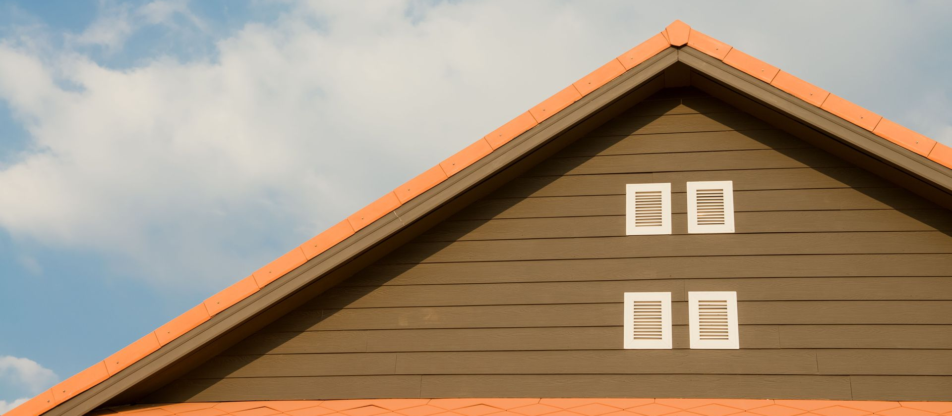 Gable roof with four attic vents installed beneath the peak, illustrating a residential roof ventilation system.