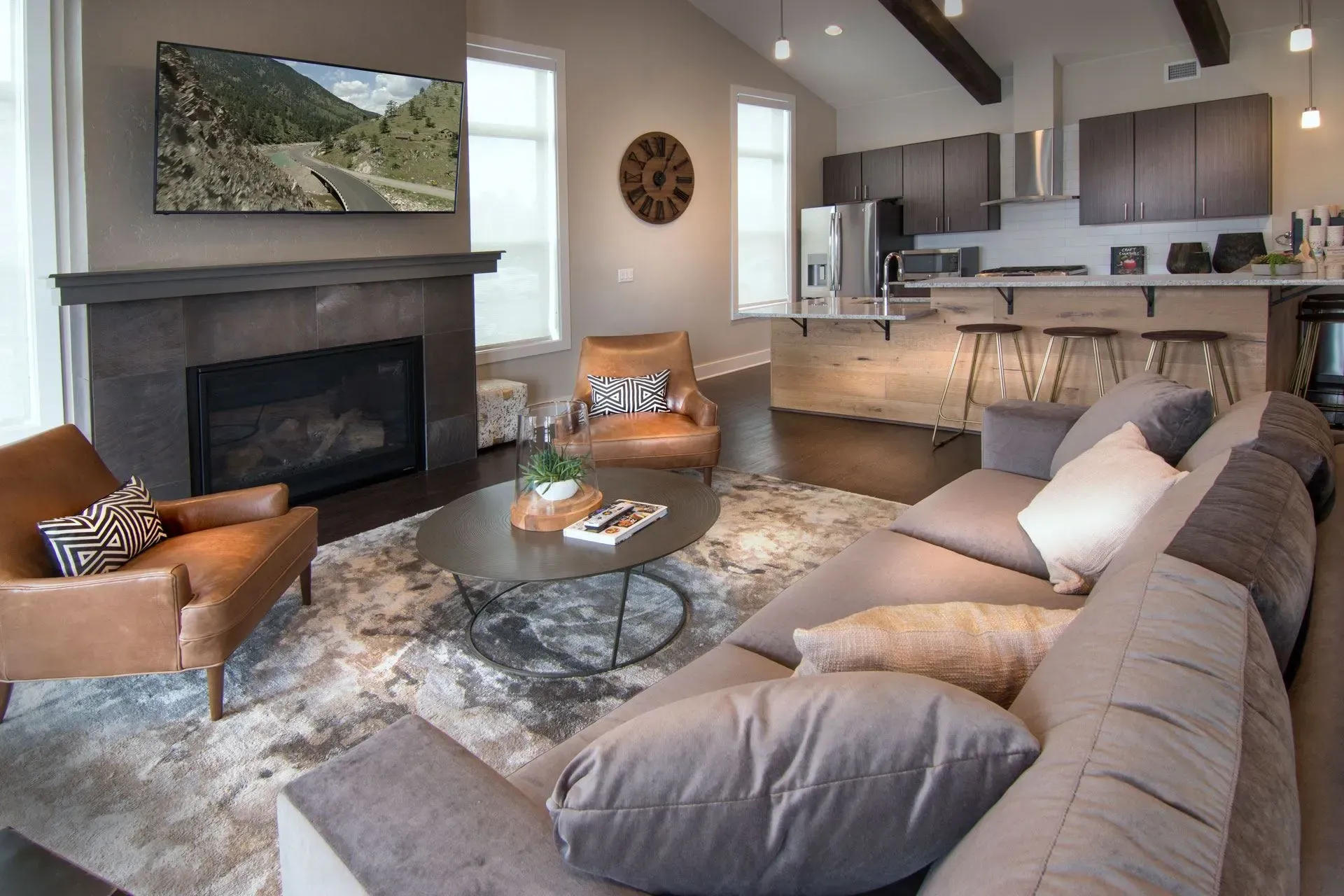 Modern living room with fireplace, television, and open-concept kitchen.