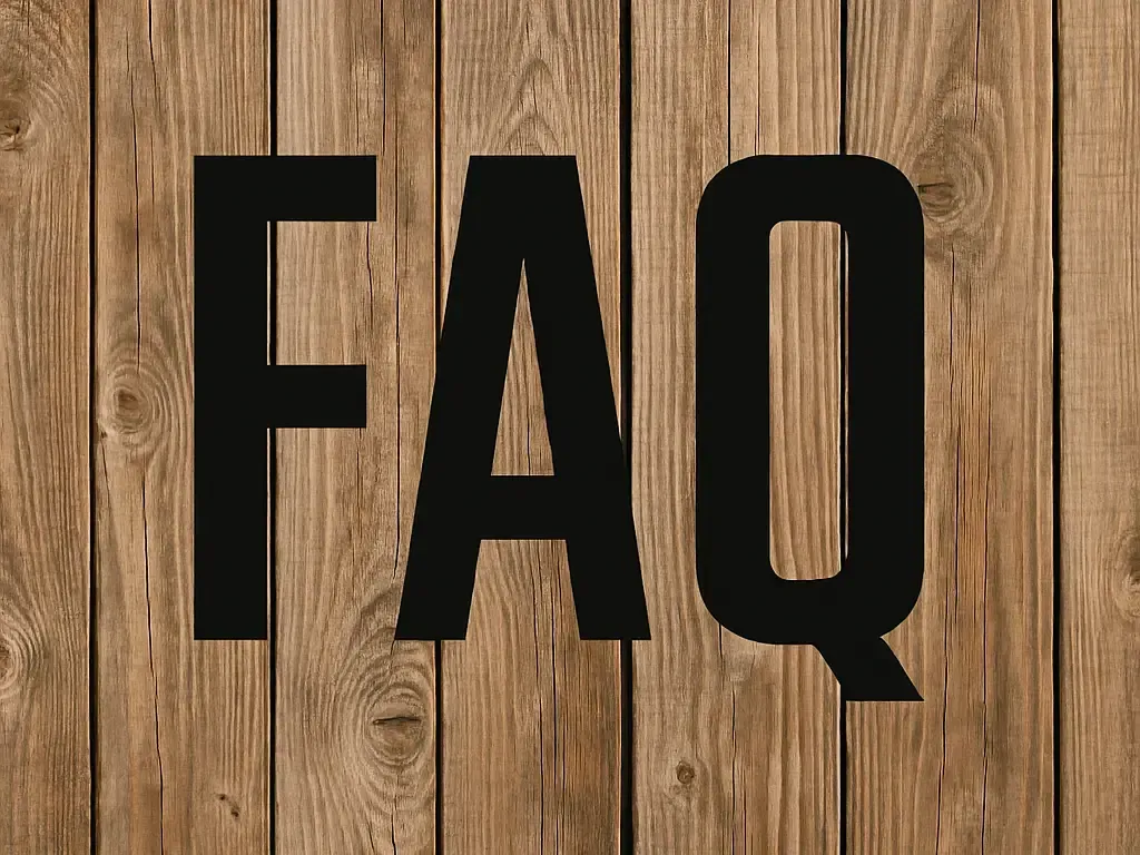 Black “FAQ” text on a wooden plank background