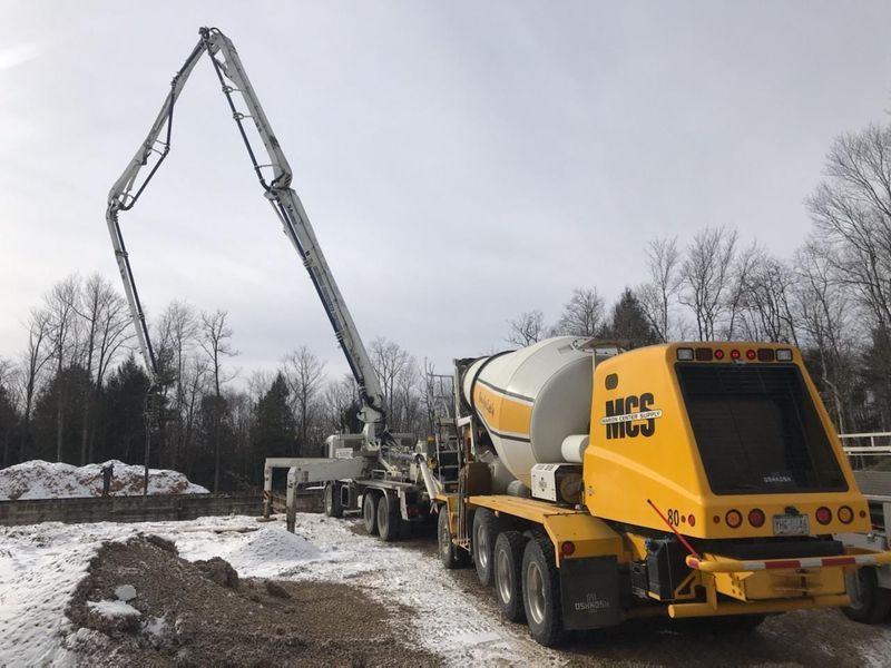 Yellow concrete mixer truck