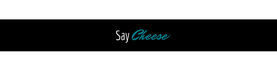 Black banner with the words “Say Cheese” in white and teal script.