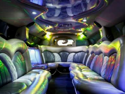 Futuristic limousine interior with blue leather seats and colorful neon lighting