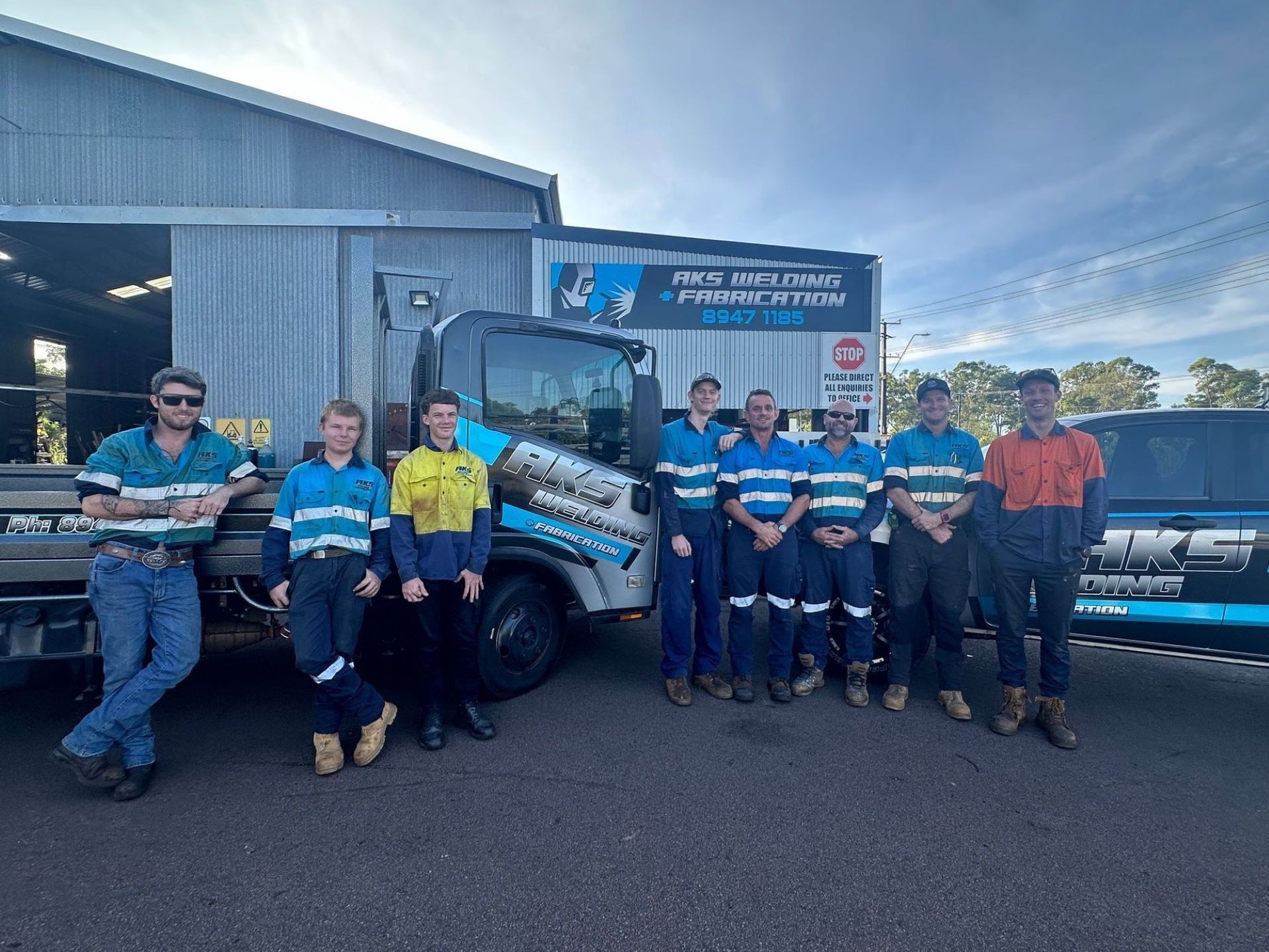 A Team of Workers in Front of a Building— AKS Welding & Fabrication in Winnellie, NT