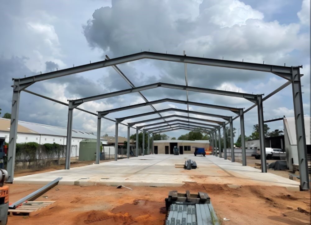 A large metal structure is being built in a dirt field — AKS Welding & Fabrication in Winnellie, NT