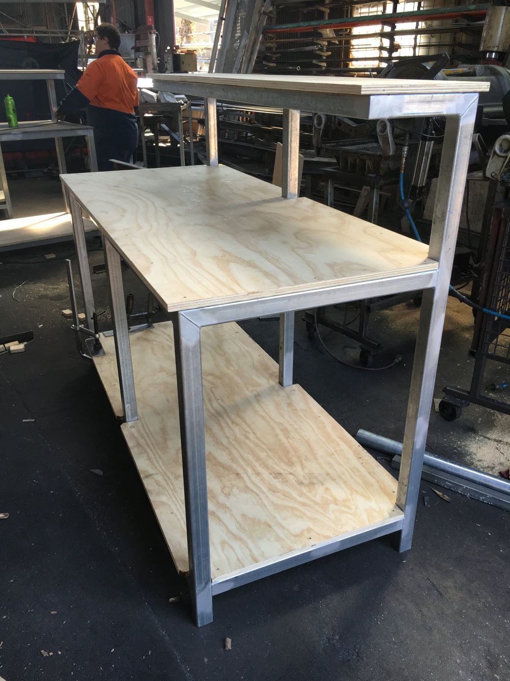 A Wooden Table With a Metal Frame in a Factory — AKS Welding & Fabrication in Winnellie, NT