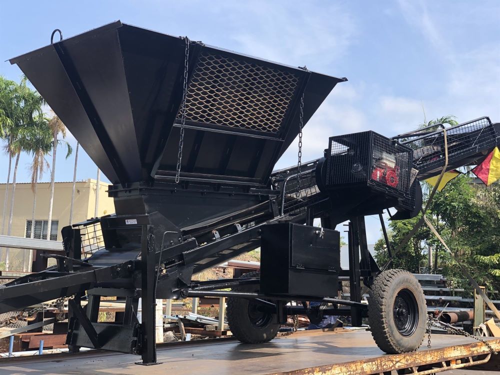 A Large Black Machine is Sitting on Top of a Trailer — AKS Welding & Fabrication in Winnellie, NT