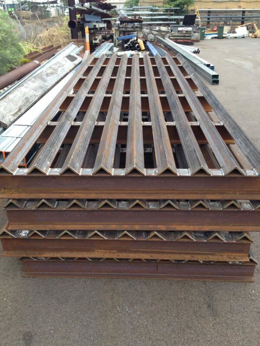 A Stack of Metal Sheets With Holes in Them — AKS Welding & Fabrication in Winnellie, NT