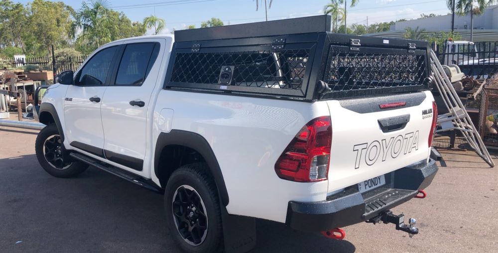 A White Toyota Hilux Truck is Parked on the Side of the Road — AKS Welding & Fabrication in Winnellie, NT