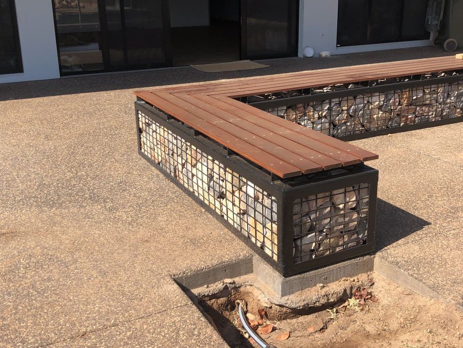 A Wooden Bench is Sitting in Front of a Building — AKS Welding & Fabrication in Winnellie, NT