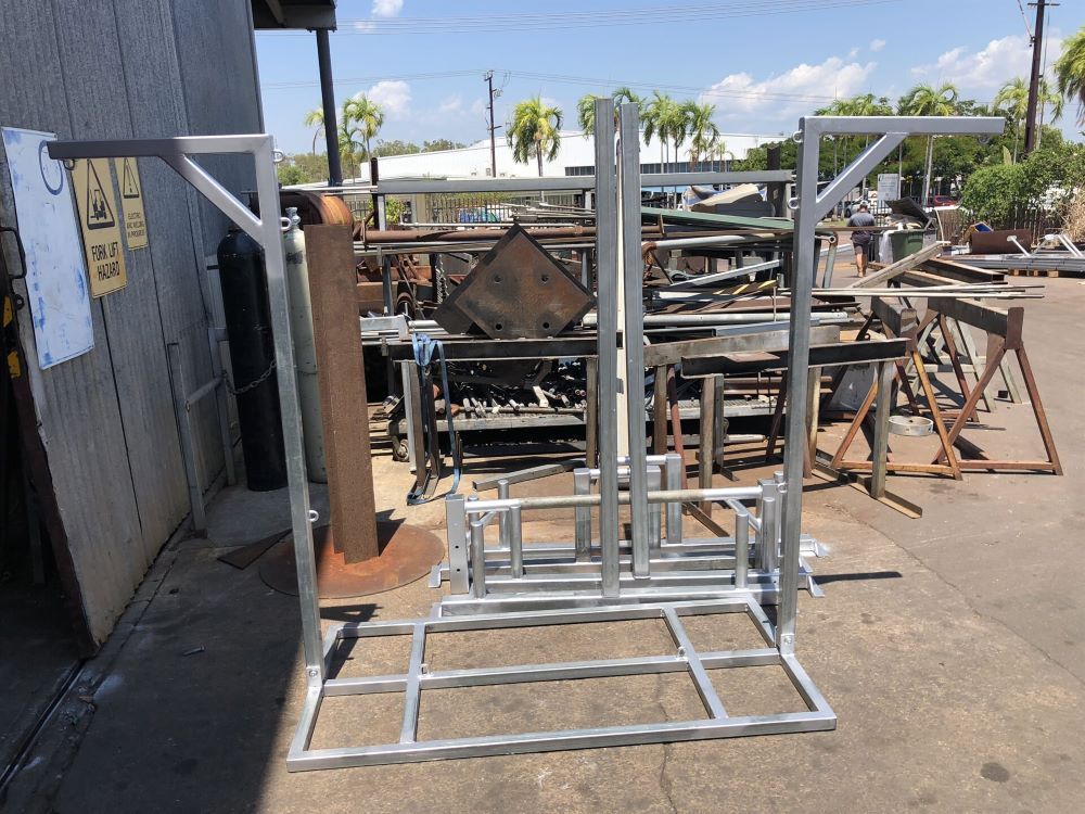A Bunch of Metal Frames Are Sitting Outside of a Building — AKS Welding & Fabrication in Winnellie, NT