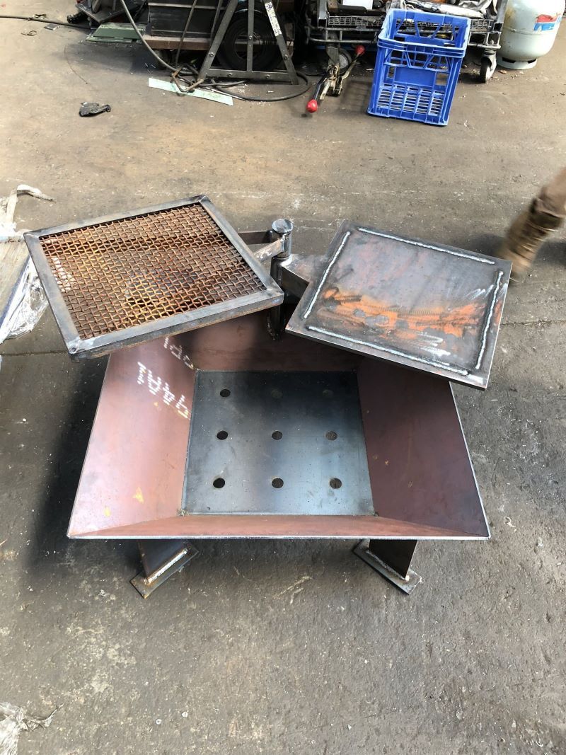 A Metal Frame is Sitting in a Warehouse Next to a Fire Extinguisher — AKS Welding & Fabrication in Winnellie, NT
