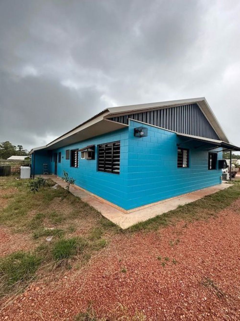 A Blue House is Sitting on Top of a Dirt Field — AKS Welding & Fabrication in Winnellie, NT
