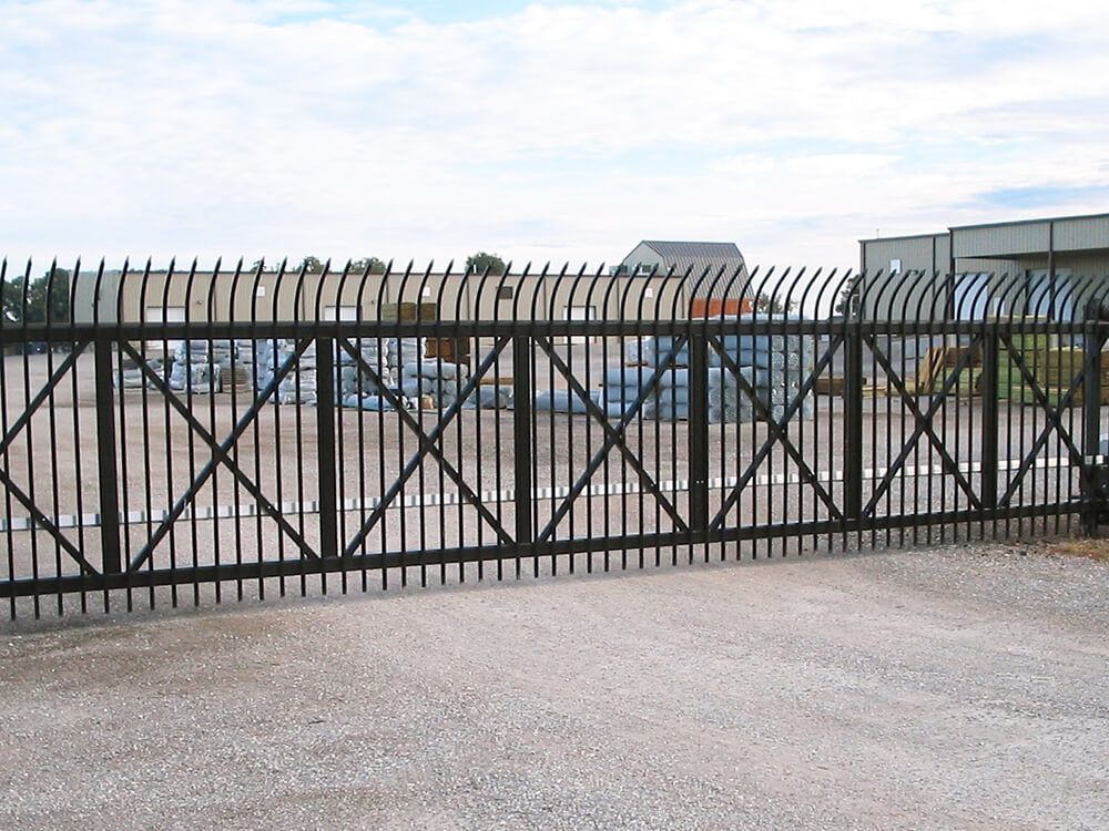 A sliding gate with a fence surrounding it