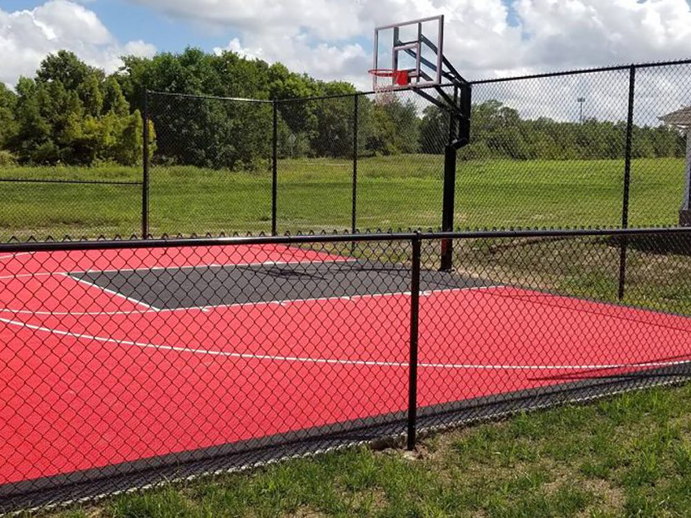 A basketball court with a chain link fence around it | fencing company springfield mo