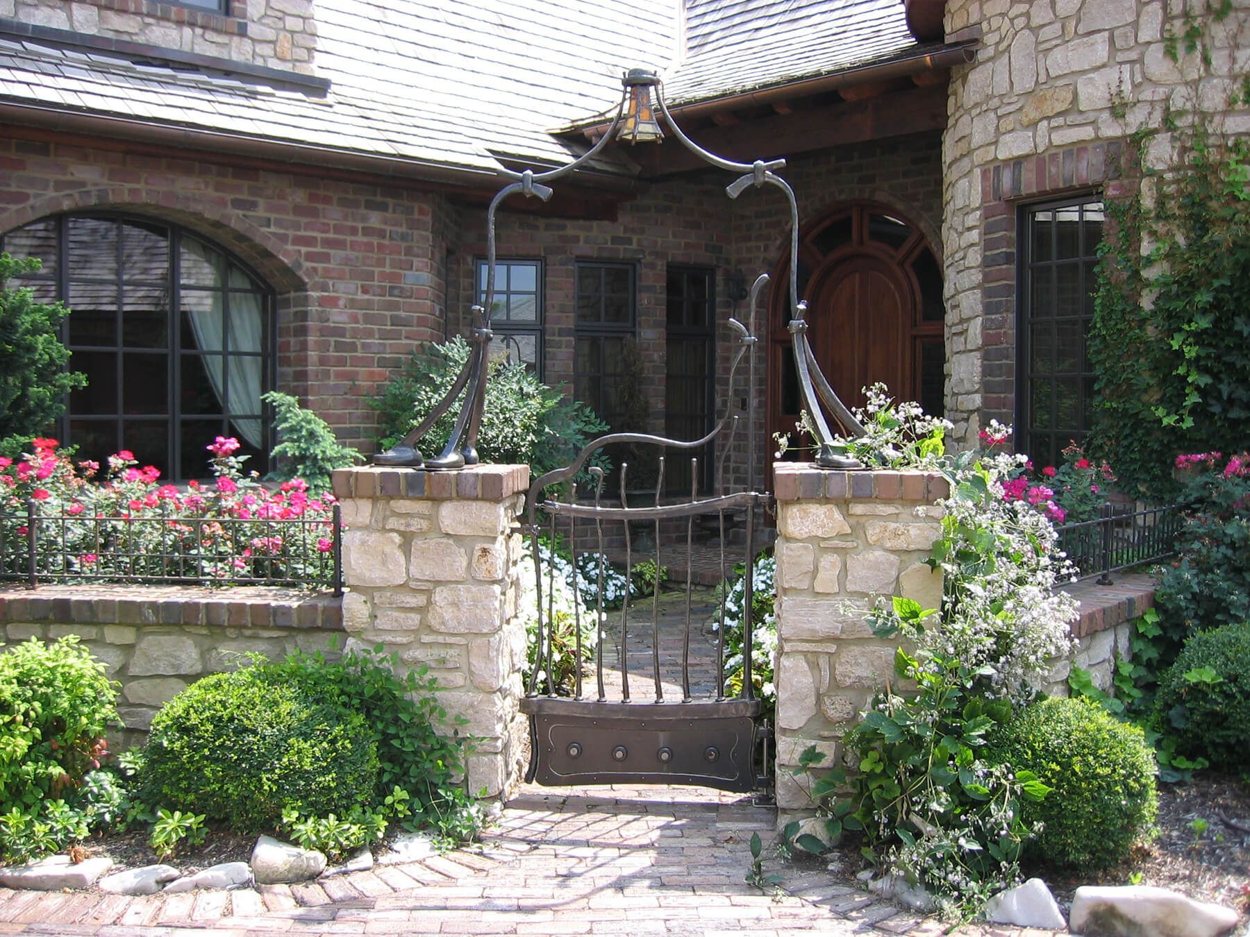 A brick house with a gate in front of it