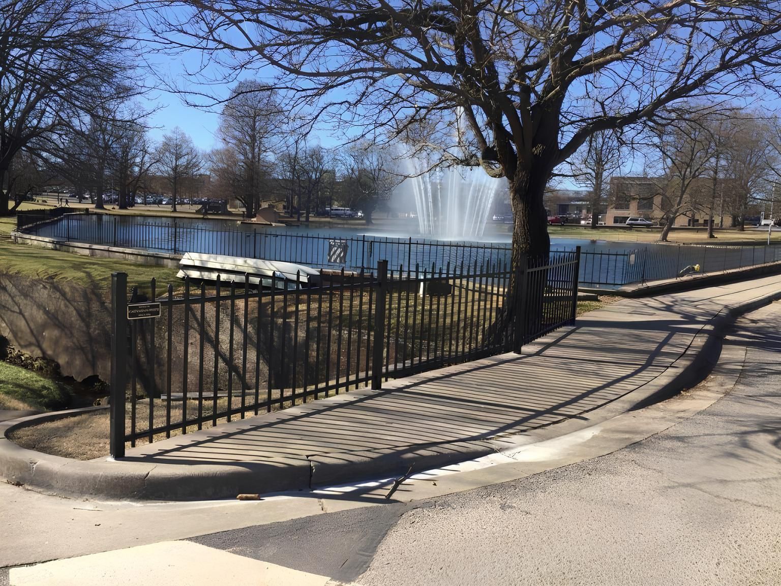 A fountain in a park with a fence around it done by best fencing company in Springfield MO, Rogersville, Willard MO