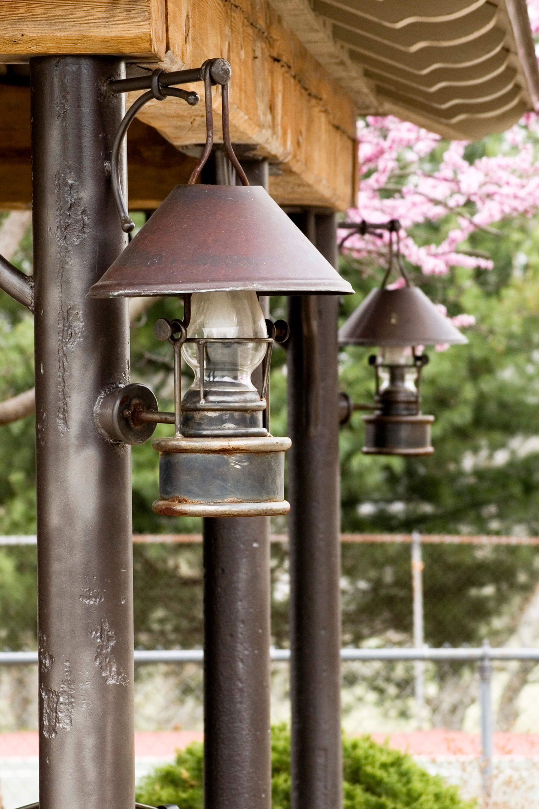A row of lanterns hanging from a wooden structure.