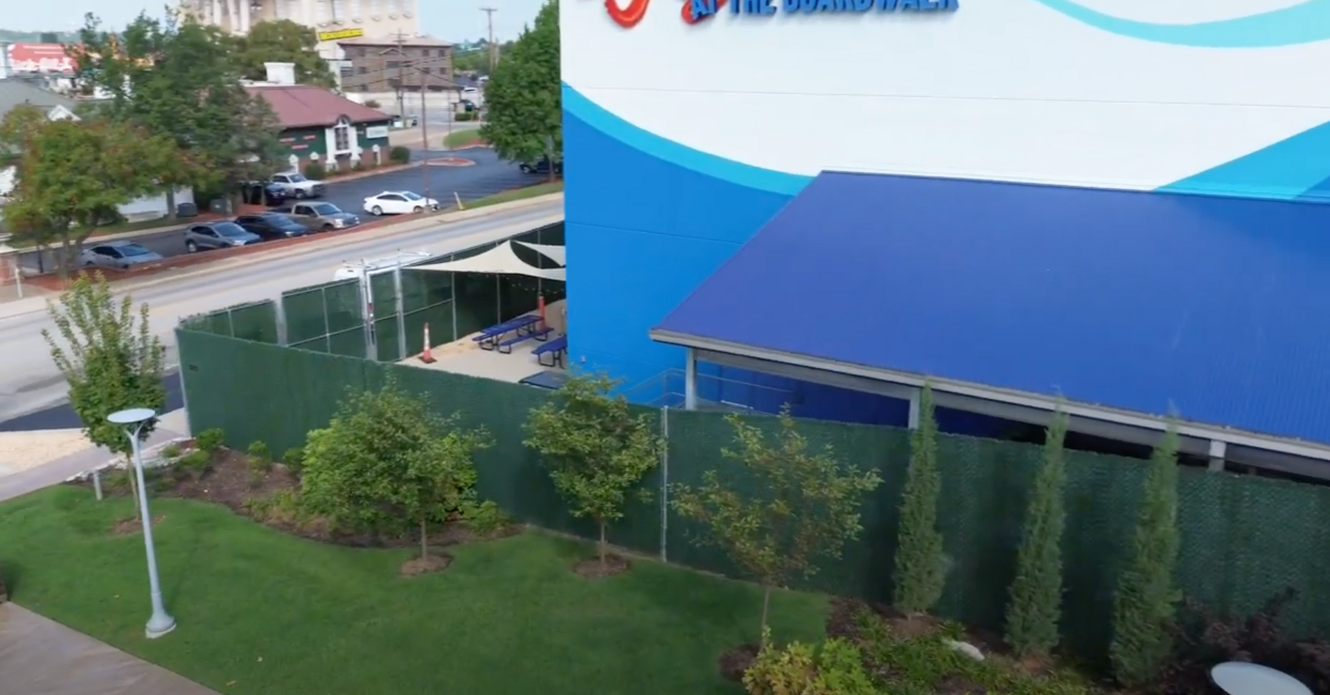An aerial view of a large building with a blue awning.