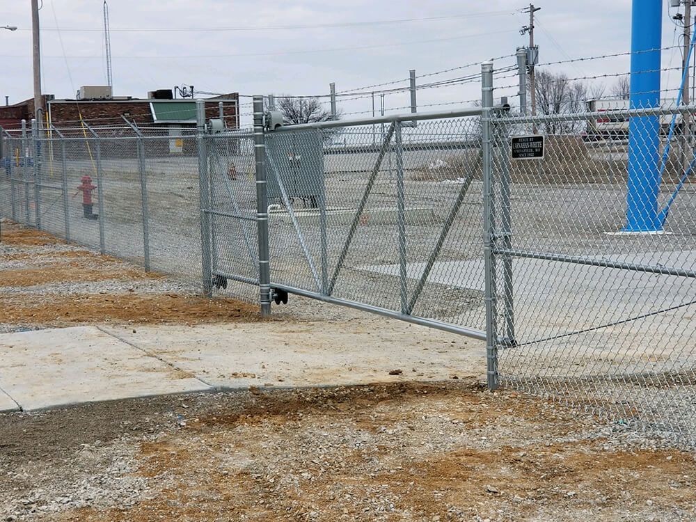 A chain link fence with a sliding gate